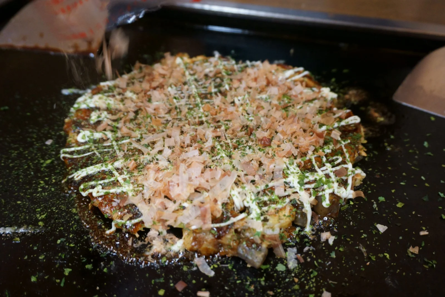 Tsukishima Monja Okoge Honten mang đến cho bạn những chiếc Okonomiyaki thơm ngon, đậm đà hương vị